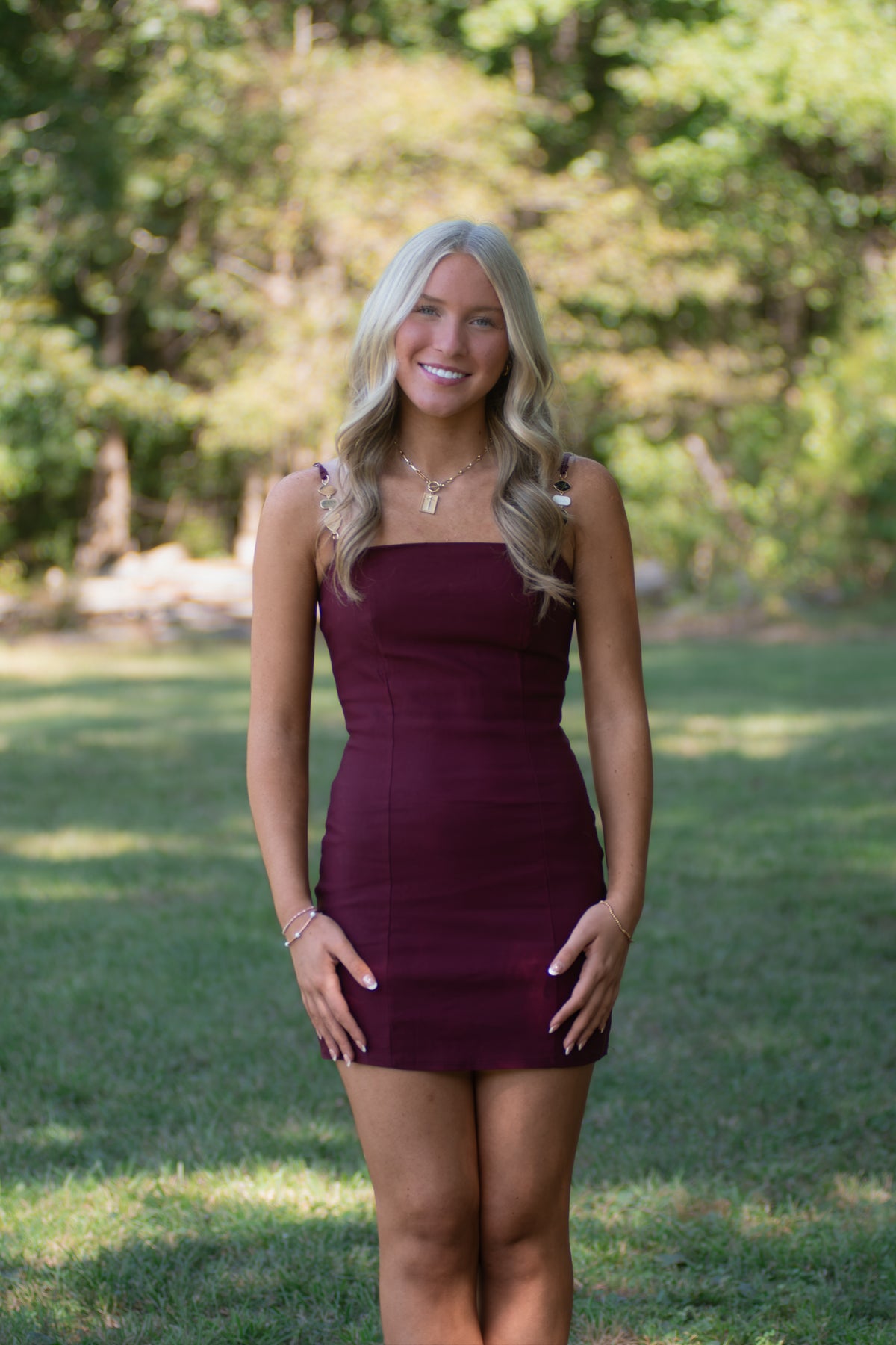 Garnet Dress with Black, White, and Gold Detailed Straps