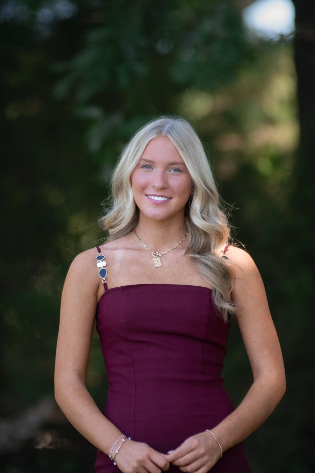 Garnet Dress with Black, White, and Gold Detailed Straps