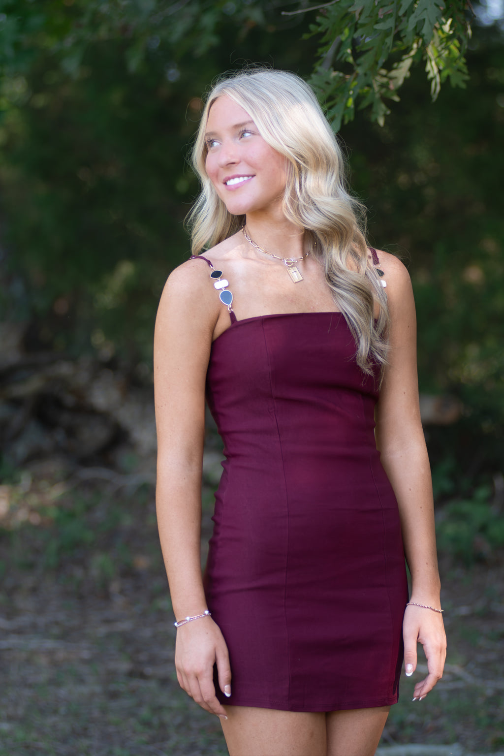 Garnet Dress with Black, White, and Gold Detailed Straps